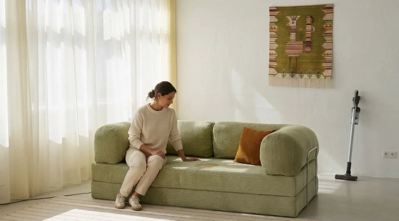 Woman looking at a stain on a OMHU sofa