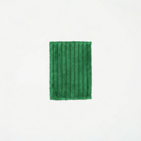 Green pleated fabric on a white background